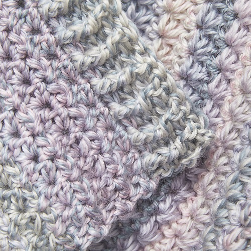 This crochet blanket is a unique pattern thanks to the beautiful daisy stitch. The Winter Flower Blanket is a really fun blanket for winter. #CrochetBlanket #CrochetPattern #CrochetAddict 
