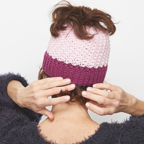 This crochet messy bun hat is sweet and simple, and fun to work on. This is a great crochet pattern to make for yourself or a woman you know. #CrochetMessyBunHat #CrochetHatPattern #CrochetPattern