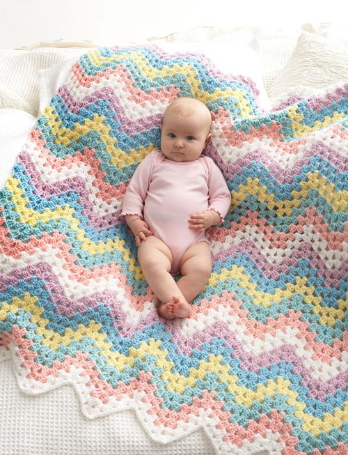 Pastel Rainbow Baby Blanket - These free crochet afghan patterns are unique and fitting for any situation. Whether you’re making a crochet baby blanket or a lapghan. #CrochetBlanketPatterns #DoubleCrochetBlankets #FreeCrochetPatterns