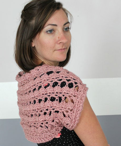 Lacy Shell Stitch Shrug - Interested in making a few shrugs for yourself and/or to gift? Check out these 27 beginner crochet shrug patterns! #crochetshrugpatterns #crochetpatterns #shrugcrochetpatterns