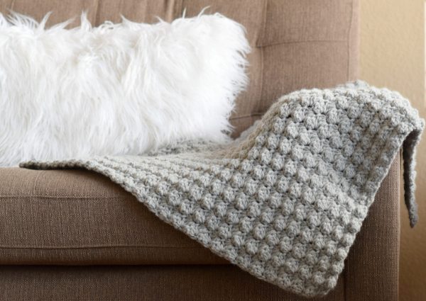 Simple Crocheted Blanket Go – To - This list of 17 easy crochet afghan patterns has a good variety of styles and stitches that will allow you to flex your crochet muscle. #easycrochetafghanpatterns #crochetafghanpatterns #crochetpatterns