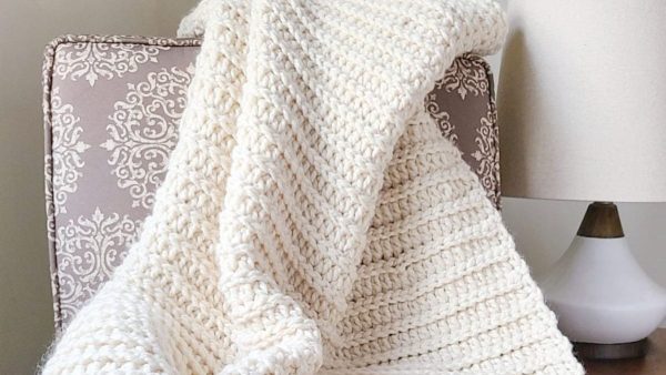The Andy Crochet Throw Blanket on a chair