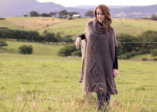 A woman wearing the Alsace Crochet Poncho