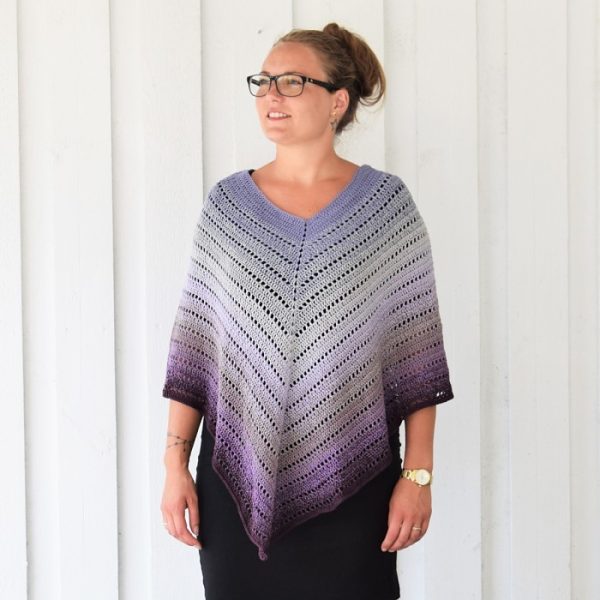 A woman wearing the Classical Attitude Crochet Poncho