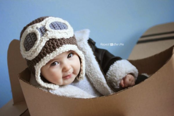a baby wearing an aviator crochet hat for photo shoot