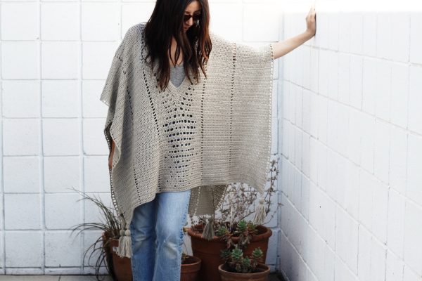 A woman wearing the Cross Country Crochet Poncho