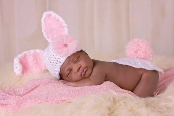 a baby wearing a bunny crochet hat and bottom cover