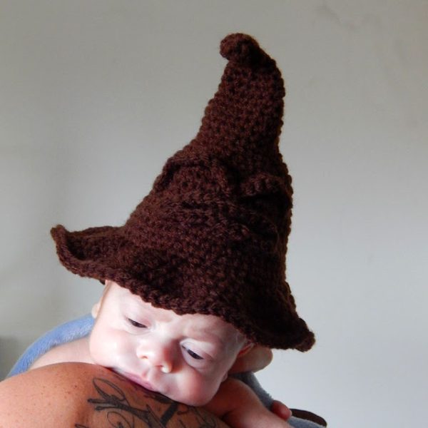 a baby wearing a wizardry crochet hat