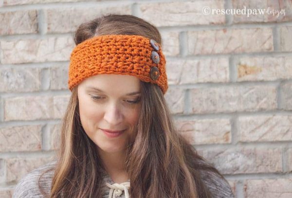 A woman wearing a Pumpkin Crochet Earwarmer