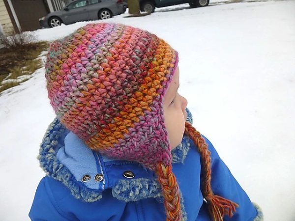 a baby wearing a seamless earflap crochet hat