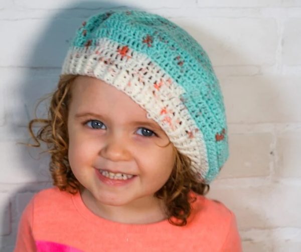 a girl wearing a beret crochet hat