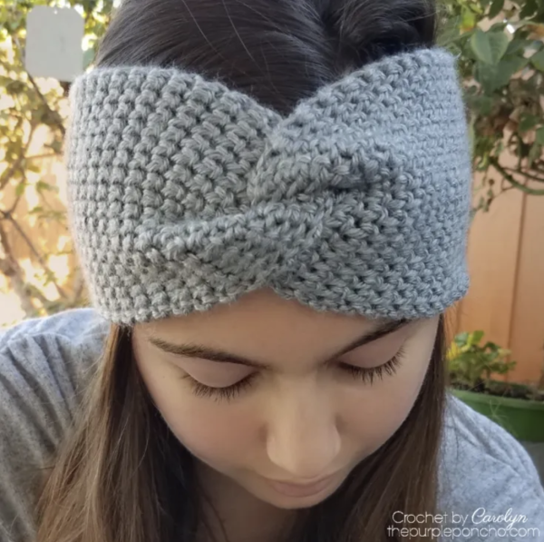 A woman wearing the Thermal Twist Crochet Headband