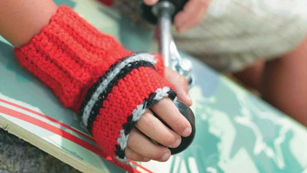 a child wearing a crochet fingerless gloves