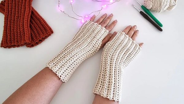 a person wearing a ridged crochet fingerless gloves